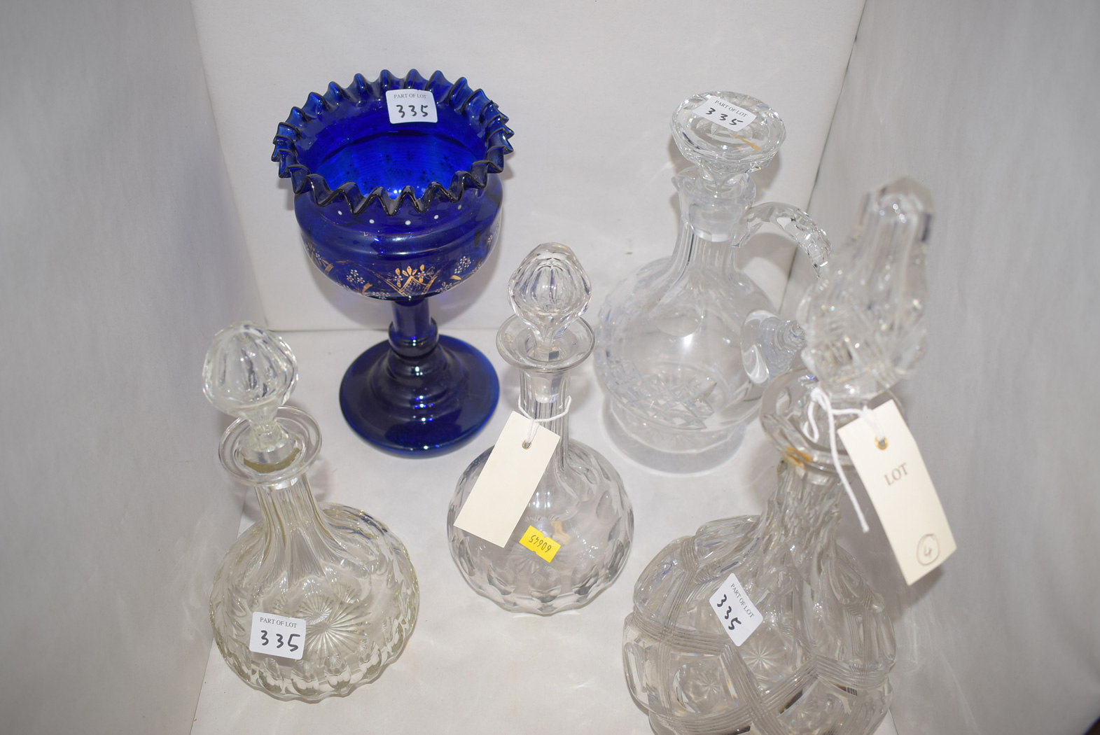 A Victorian heavily cut glass decanter and stopper; a pair of cut glass decanters;