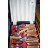 A set of stag horn-handled steak knives and forks, in fitted case.