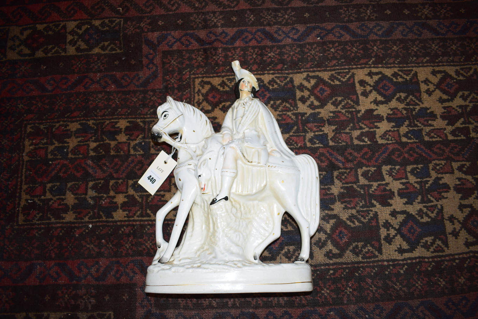 A Staffordshire figure of a man on horseback with gilded highlights.