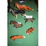 Three Beswick ware models of foxes, one large and two small; two ponies; and an Alsatian dog.