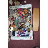 A large quantity of costume jewellery, including: a large stone and other bead necklaces.