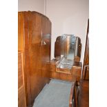 A mid 20th Century figured walnut walnut three-piece bedroom suite, to include: a two door wardrobe,
