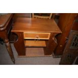 A stained wood occasional table with magazine rack with single drawer.