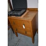 An oak chest of two drawers.