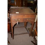 An late 19th Century oak clerk's desk, with hinged sloping top above two short drawers.