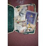 A large quantity of costume jewellery and watches in a suitcase.