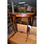 A 20th Century mahogany oval occasional table with lyre-shaped supports.