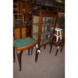 An Edwardian inlaid mahogany display cabinet; together with a side table; a two-tier coffee table;