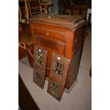 A stained oak side cabinet with dummy drawer and panel door;