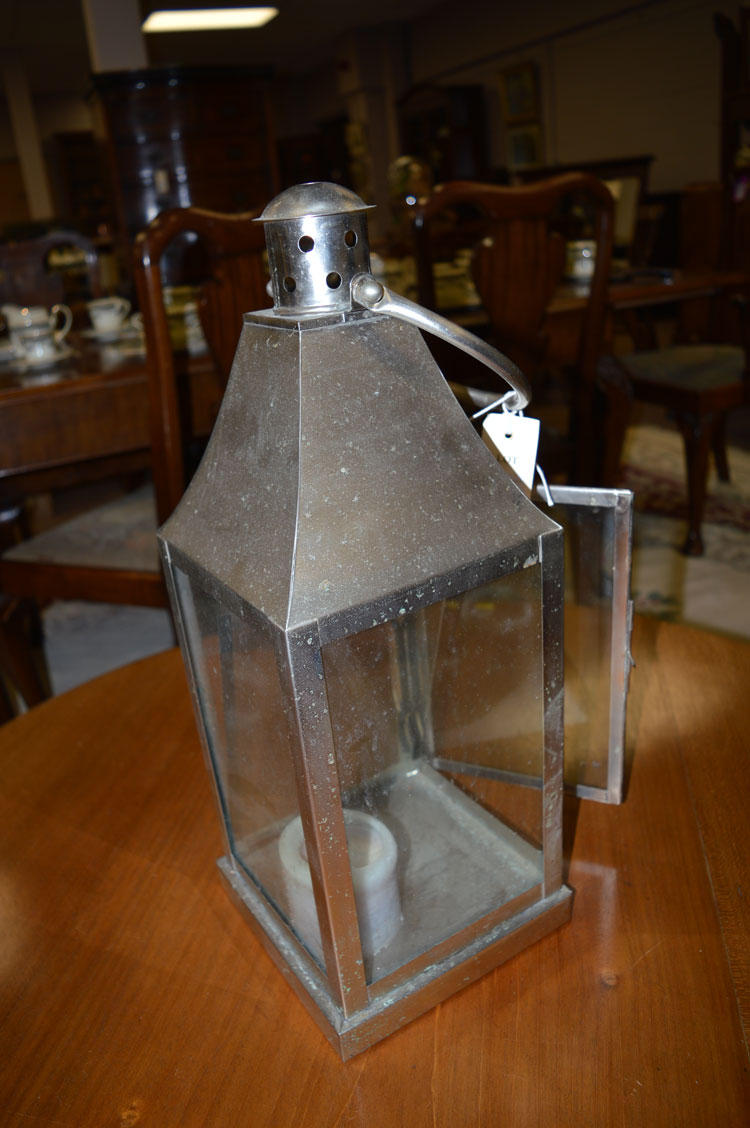 A hanging candle lantern in brushed steel.