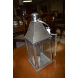 A hanging candle lantern in brushed steel.