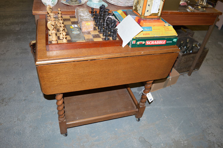 An oak drop leaf trolley with barley twist supports.