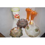 Three purple Carnival glass dishes; a pair of orange vases;
