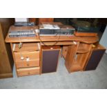 A stained pine desk fitted sliding surfaces and drawers.