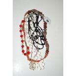 A hardstone white metal and coral necklace; a black stone necklace; and others.