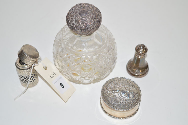 A cut glass scent bottle with silver cover;