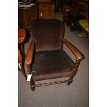 An early 20th Century oak open armchair with barley twist supports and bobbin stretcher.