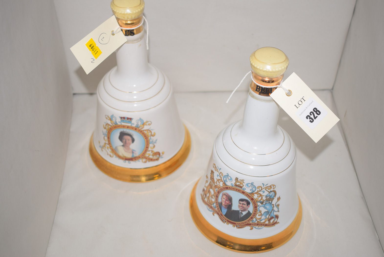 Two Wade hand bell-shaped ware whisky decanters,