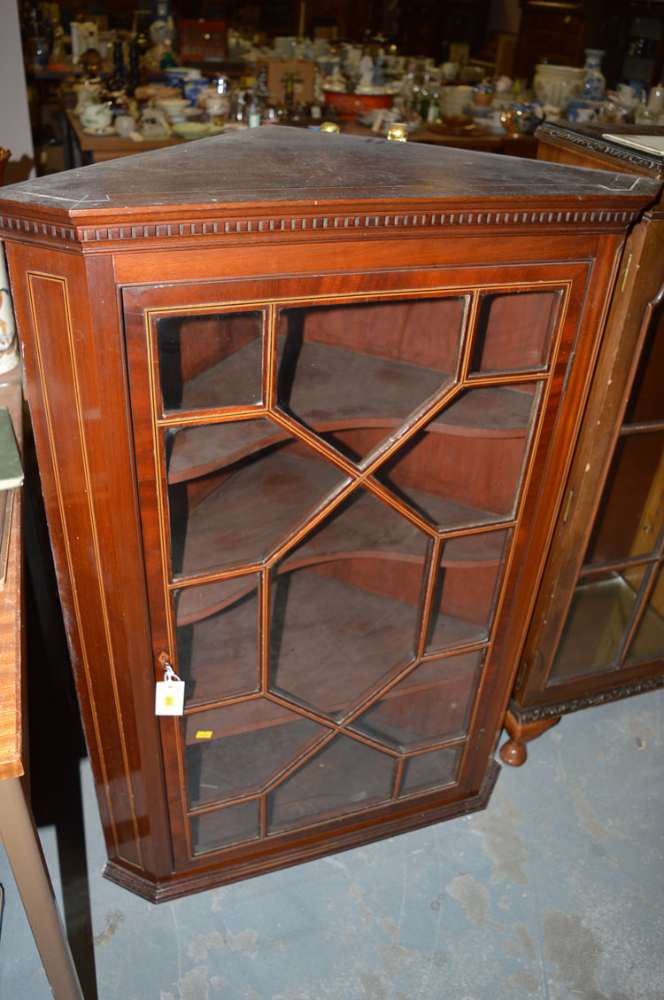 An Edwardian mahogany hanging corner cabinet, fitted astragal glazed door enclosing shelves.