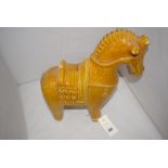 A reproduction ceramic figure of a Chinese horse, saddle and bridle (damaged and repaired).