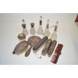 A quantity of cut glass scent bottles and a dressing table pot with silver covers and collars;