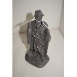 A reproduction cast resin bronze effect "Heredities" figure of an Angler holding a pike, with rod,