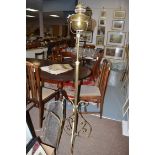 An early 20th Century brass floor standing oil lamp,