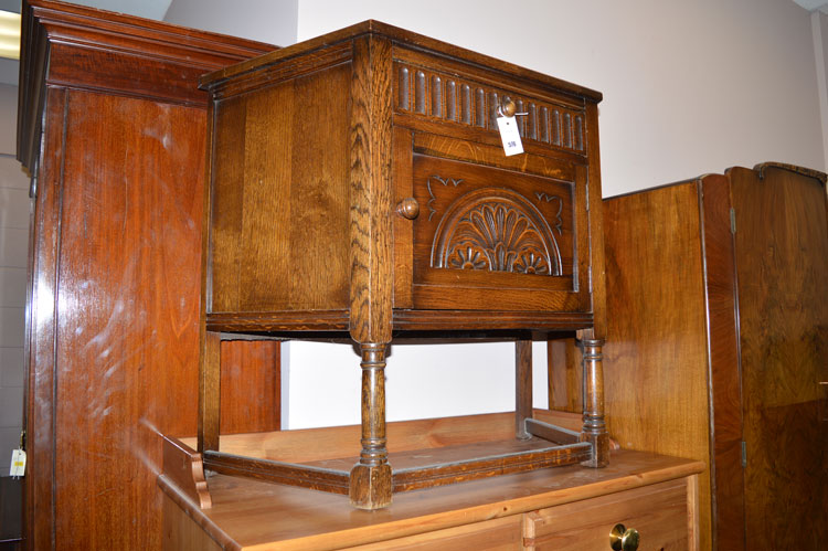 A mid 20th Century carved oak credence cabinet, fitted a single drawer and cupboard door.