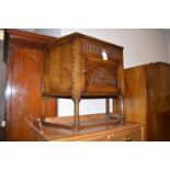 A mid 20th Century carved oak credence cabinet, fitted a single drawer and cupboard door.