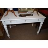 A white painted pine table fitted three drawers, raised on turned legs.