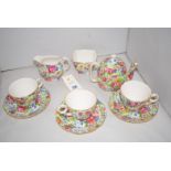 Three Royal Winton 'Summertime' pattern coffee cups and saucers; a small coffee pot; a cream jug;