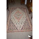 A Kilim rug with diamond and stylized leaf designs.