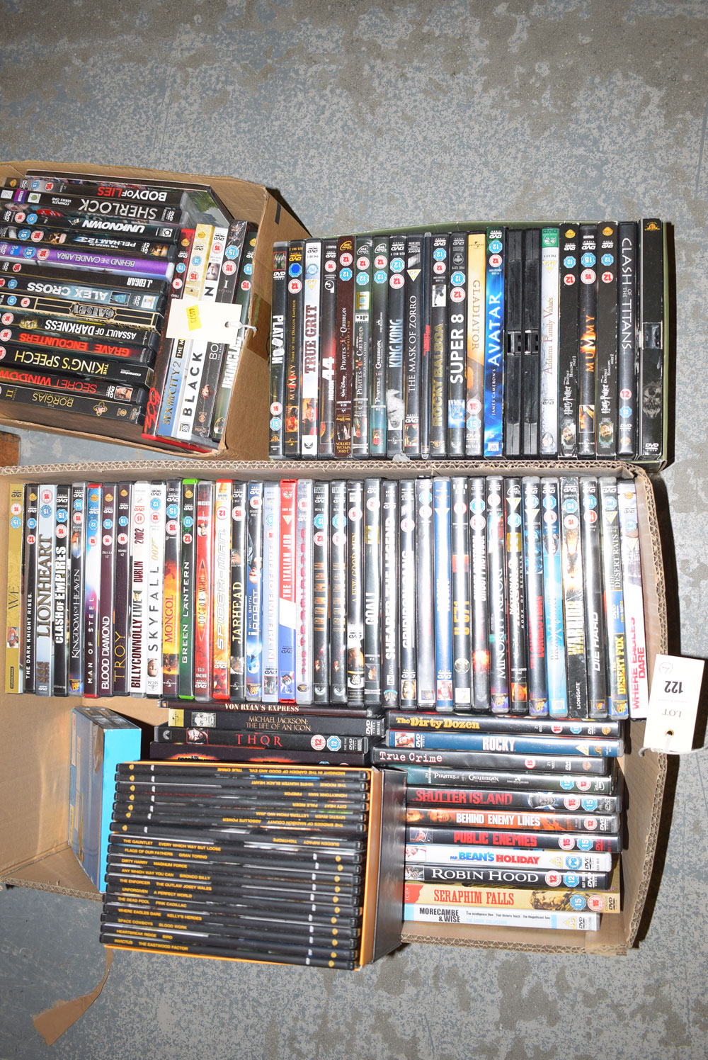 Four boxes of DVD's, including, "True Grit", "Toon", "Public Enemies", "The Kings Speech", etc.