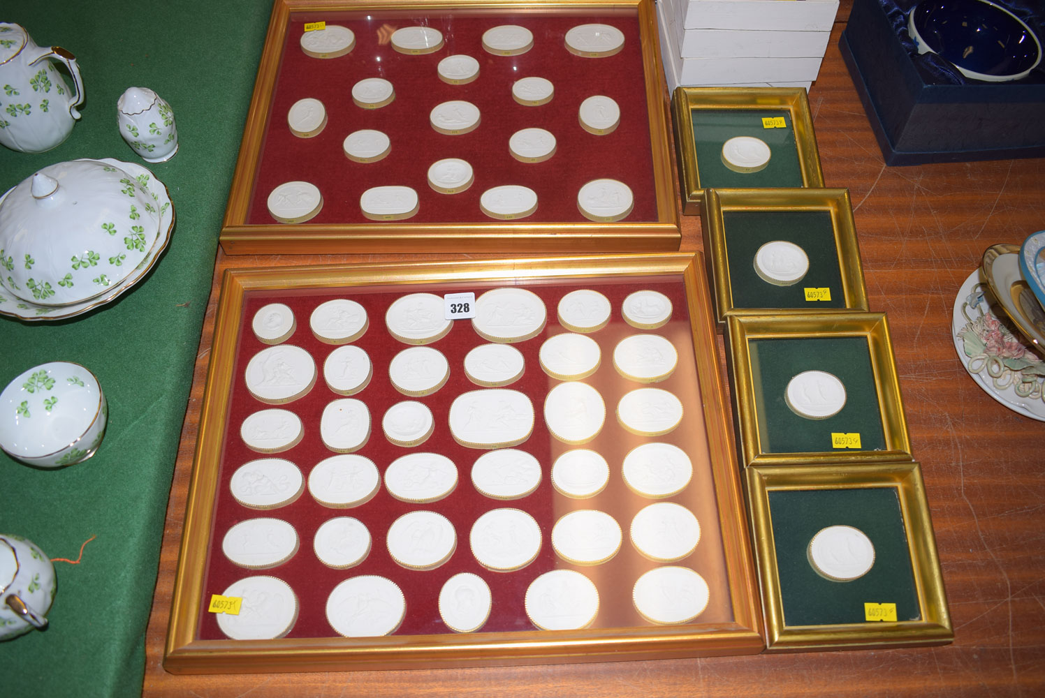 A collection of reproduction cast intaglio's seals, some framed individually,