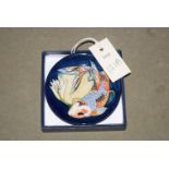 A modern Moorcroft dish decorated with a fish, in original box.