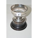 A silver miniature rose bowl, by W.H.S., Birmingham 1904, of reeded design, on ebonised pedestal.