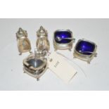 A five-piece silver condiment set, to include: mustard pot,