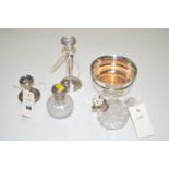 Two silver candlesticks, a silver bottle coaster with turned wooden base,