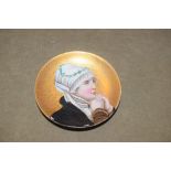 A Continental porcelain dish decorated with a portrait of a young lady.