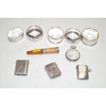 Five silver napkin rings; a silver cased fob watch; three silver vesta cases;