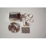 Silver items, to include cigarette box, cigarette case, ash-tray and four napkin rings.