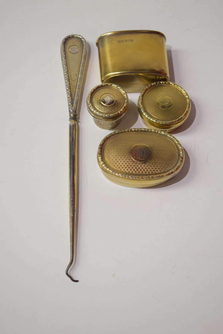 Silver gilt dressing table bottle covers and base; together with a button hook.
