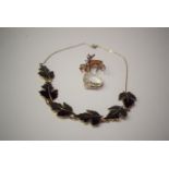 A silver gilt and black enamel maple leaf pattern necklace;