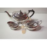 A silver three piece tea set, to include tea pot, two handled sugar bowl and helmet form cream jug,