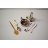 A quantity of silver items including a sugar castor, bottle coaster, pair of pepperettes,