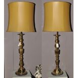 A pair of 18th Century style brass table lamps, of oversized candlestick form,