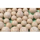 A collection of polished granite balls, of varying size, twenty-four small, ten large.