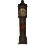 Orme, Newport: a stained and carved oak longcase clock, the brass 11 3/4in.