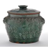 Green glaze moulded pottery jar and cover,