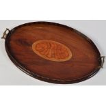 A late 19th Century inlaid mahogany oval tray, with shell pattern panel and brass mounted handles,
